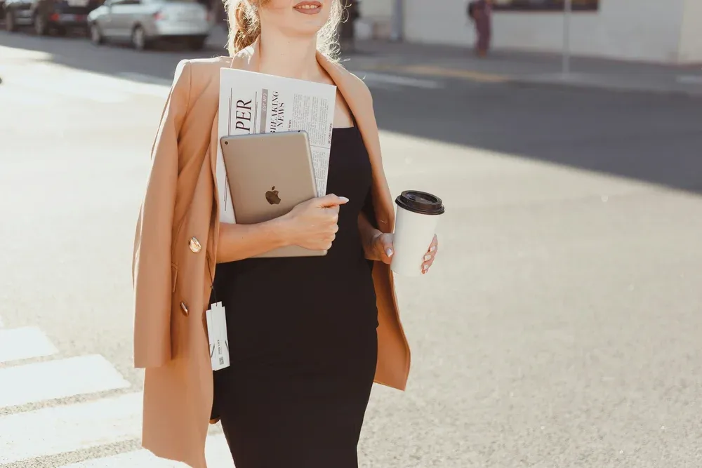 A stylish professional woman in a crosswalk